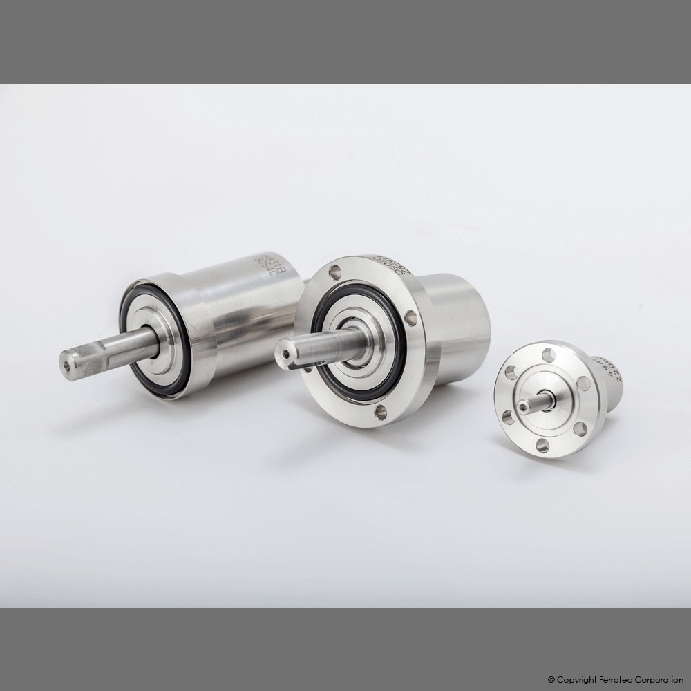Three stainless steel ferrofluidic vacuum seals in different sizes