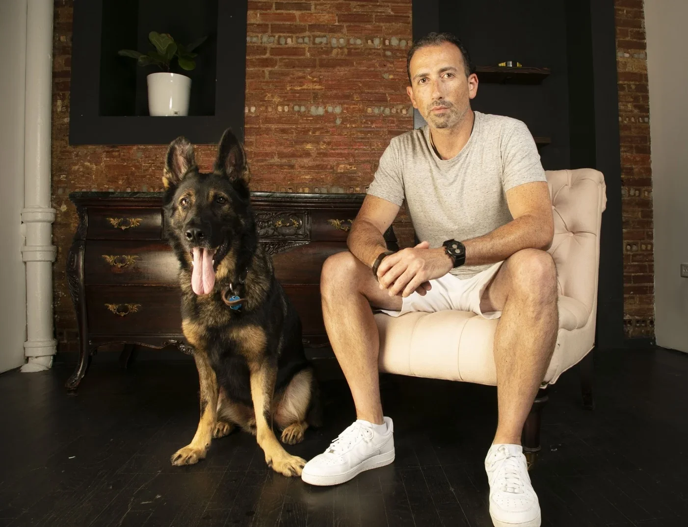 Fi co-founder Jonathan Bensamoun seated beside his German shepherd