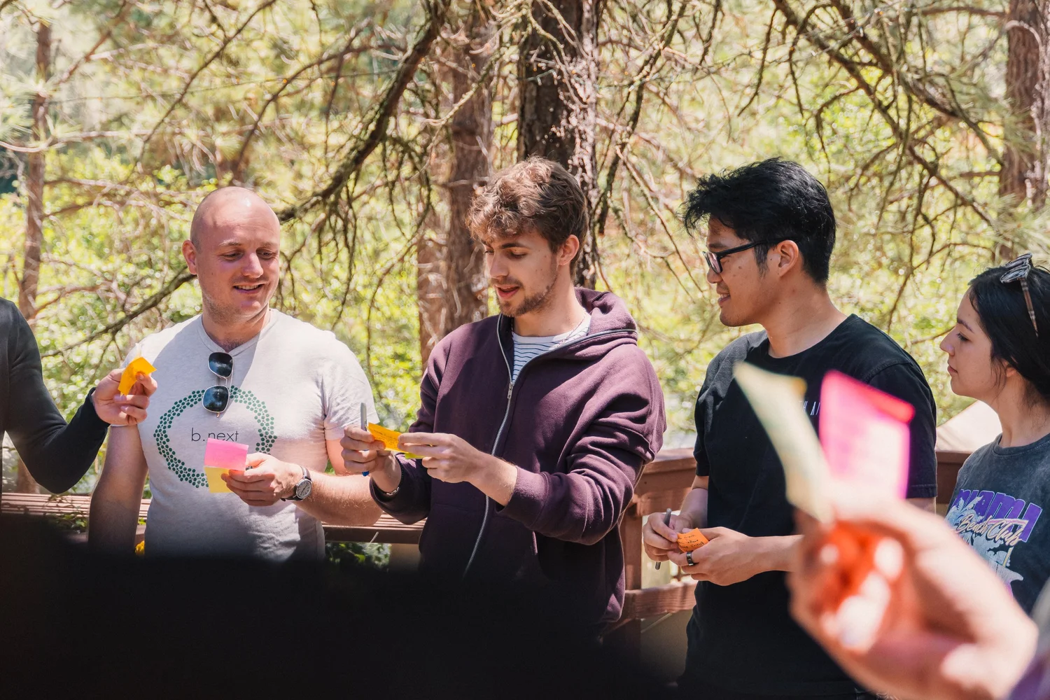 People at a Fifty Years 5050 gathering outdoors, discussing ideas with colored notes