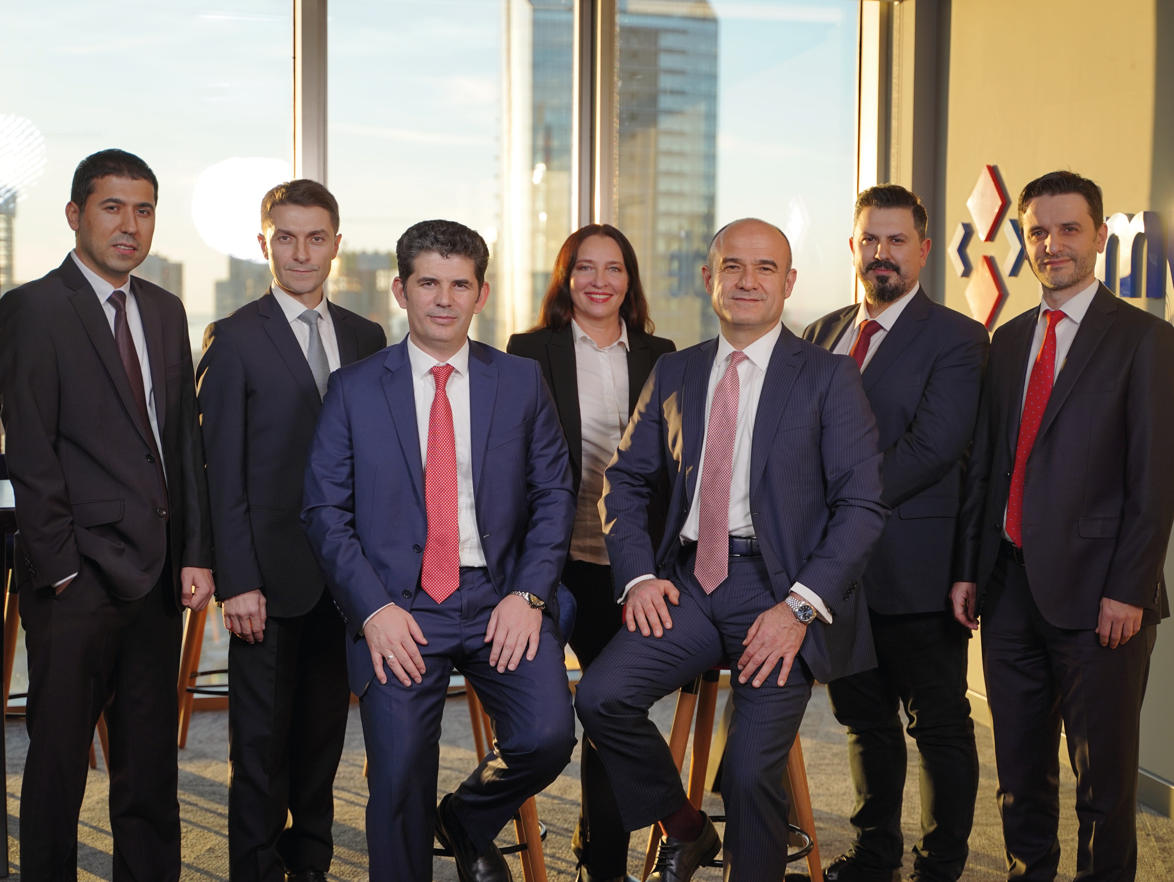 Seven members of the Fimple team pose together in an office
