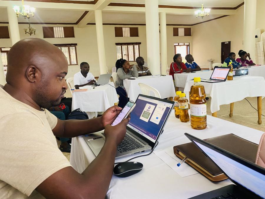 Participants using laptops and phones at a workshop pictured on Finding XY’s agricultural incubator page