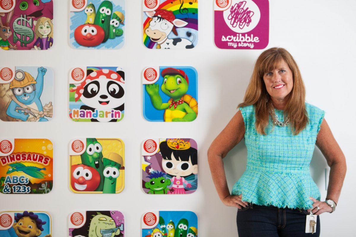 Fingerprint co-founder Nancy MacIntyre in front of children's app artwork