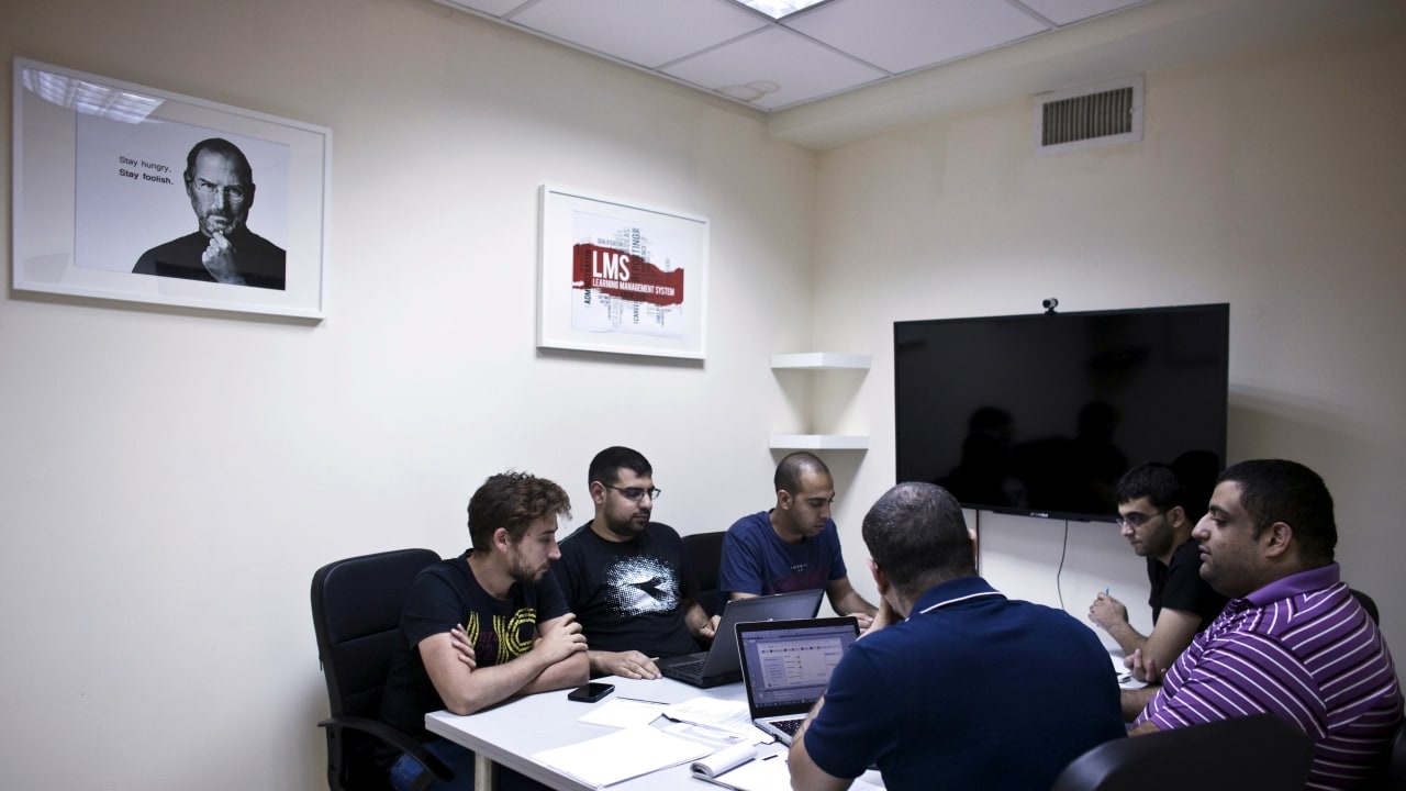 Firas Jabbour with colleagues around a meeting table at Edunation's Nazareth office