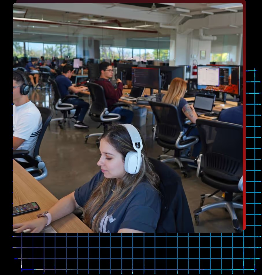 People working at computers in a First Factory office