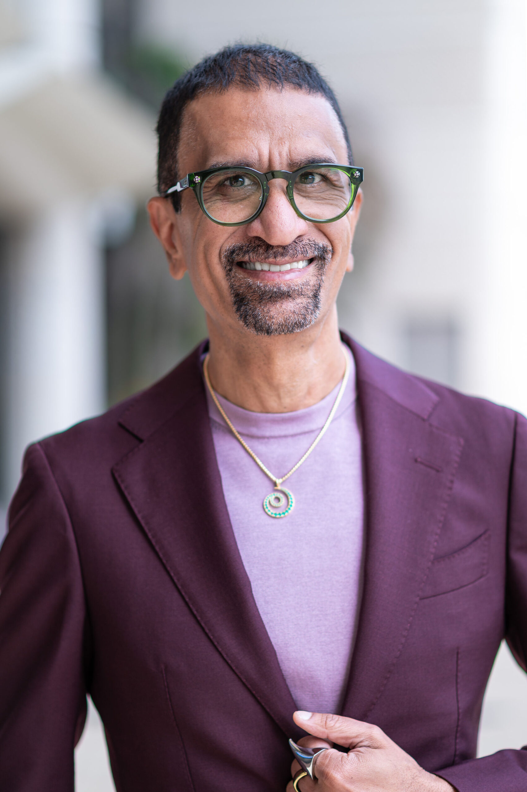 First Insight founder Nitin Rai wearing glasses and a purple jacket