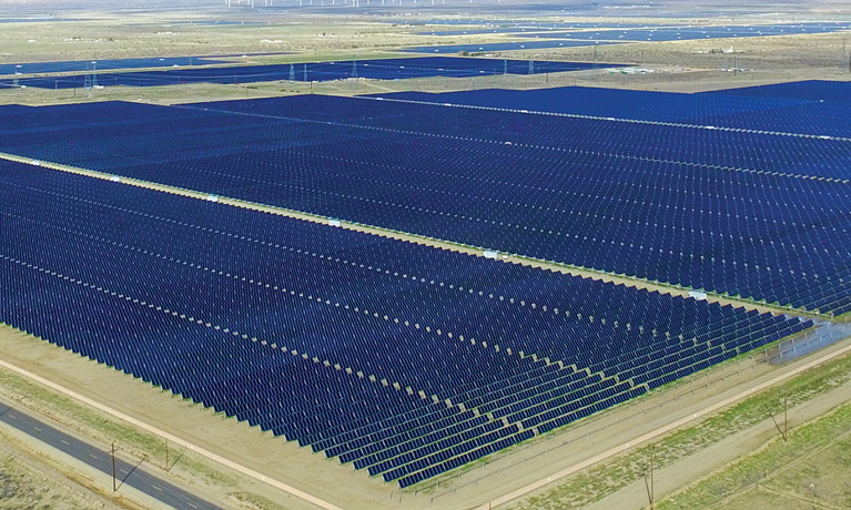 Aerial view of rows of photovoltaic modules at a solar project