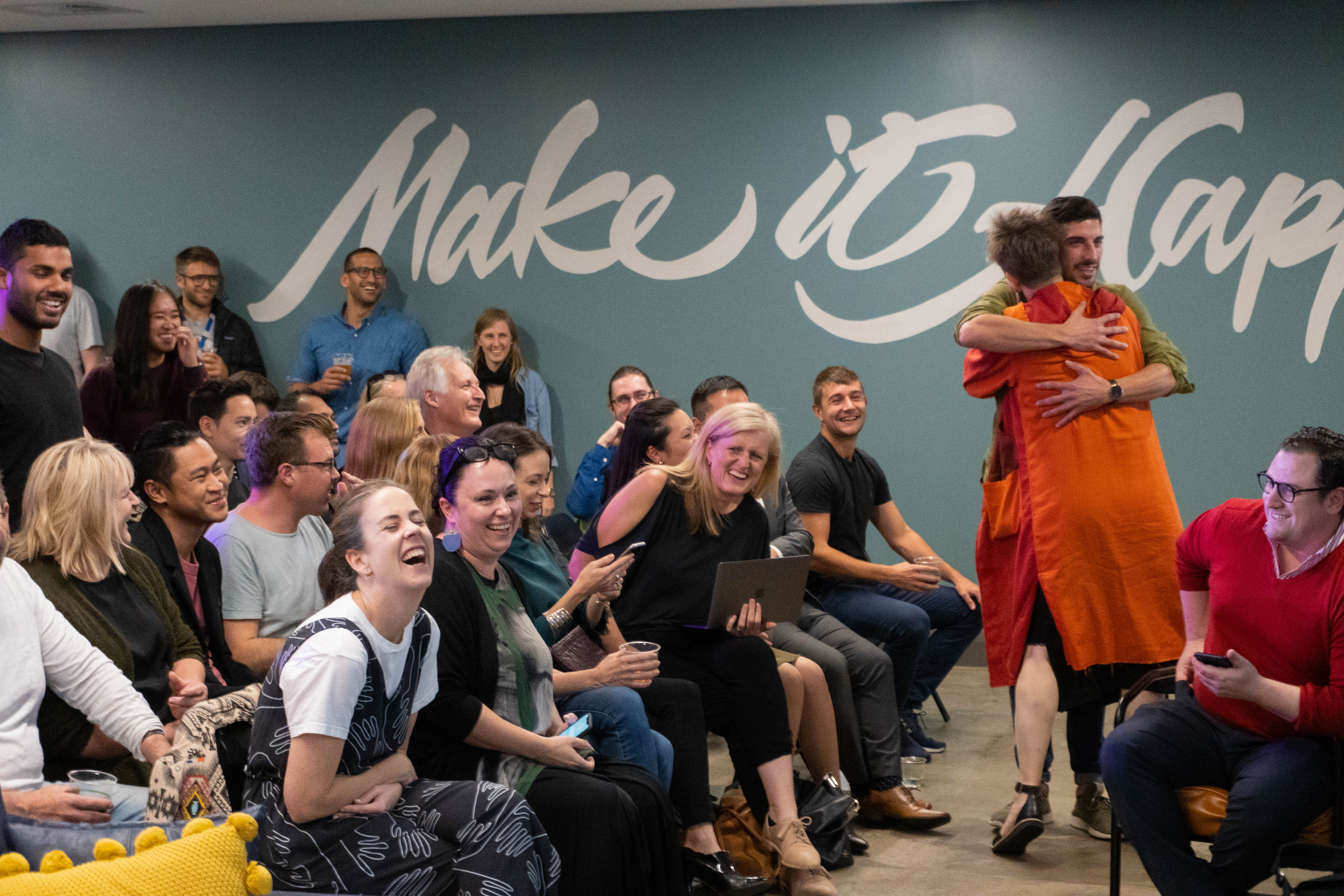 People laughing and embracing during a Fishburners community gathering