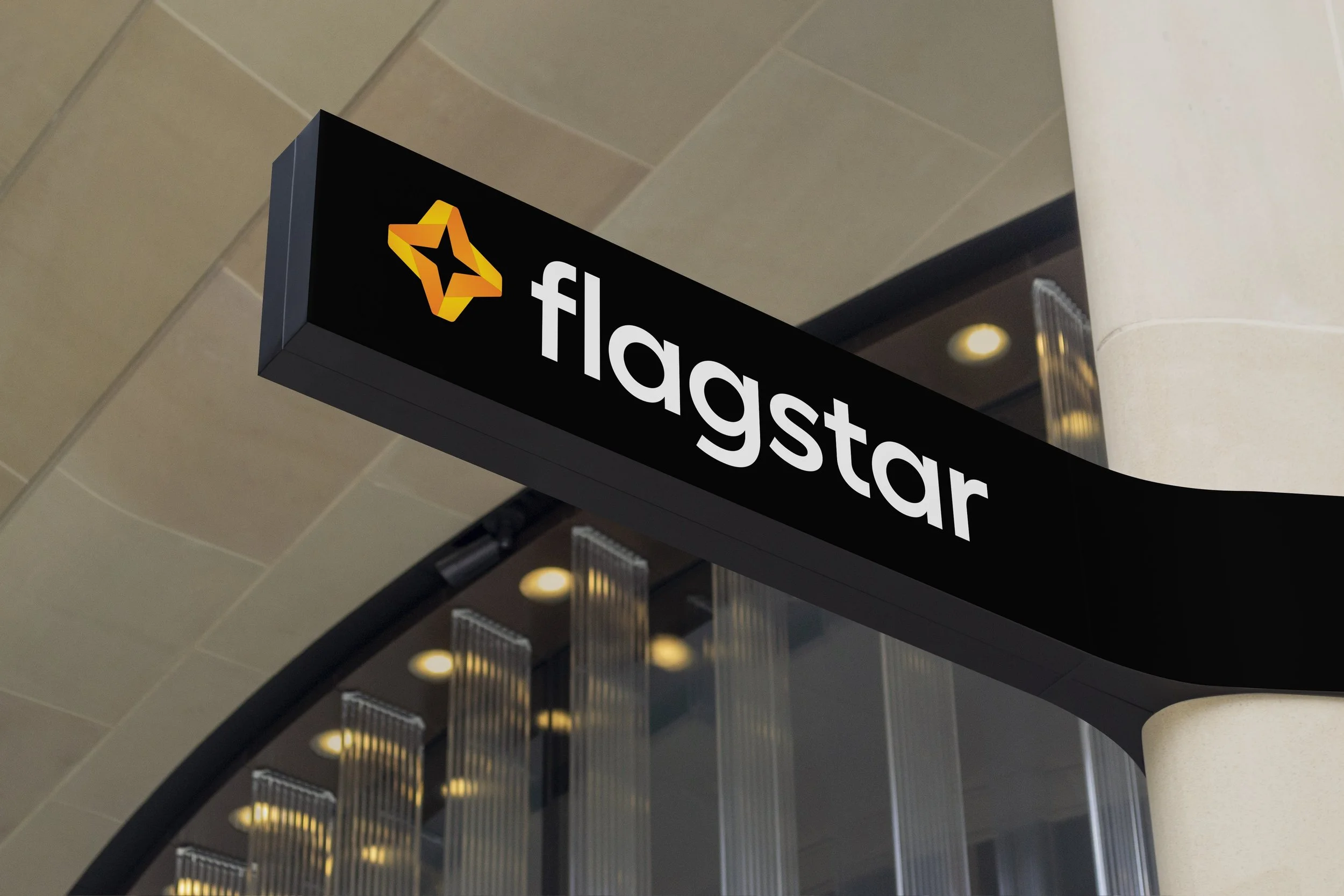 Flagstar’s orange and yellow star on black exterior branch signage, shown in its brand-design portfolio