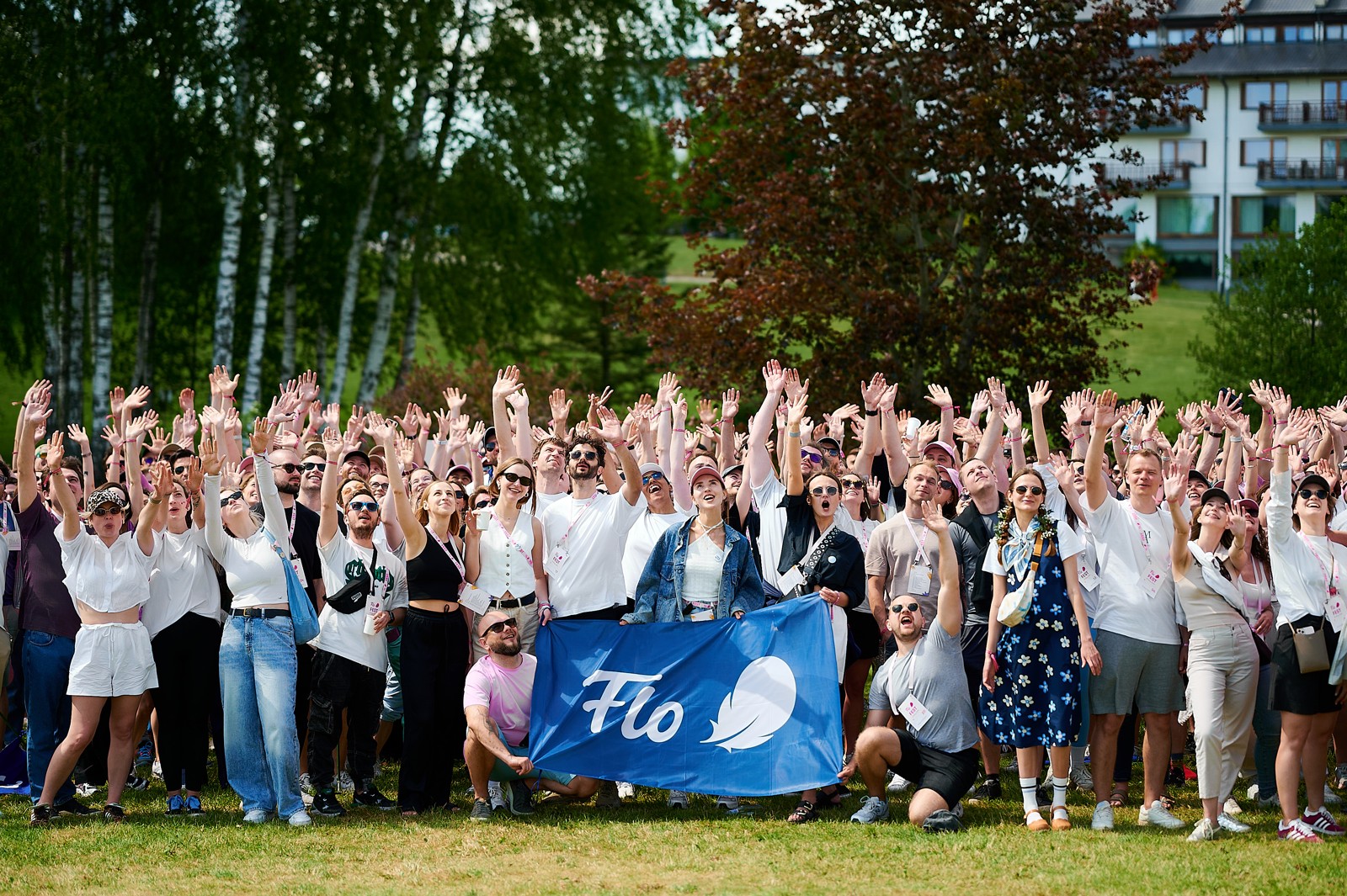 Flo employees gathered outdoors in a 2024 company photograph.