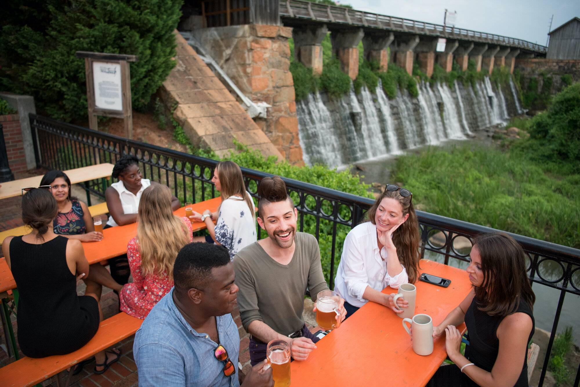 A group gathered beside the canal at Columbia's Riverfront Park during a destination photography shoot