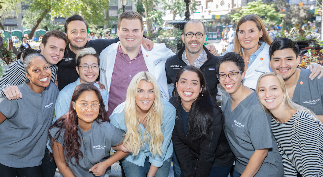 Florent Peyre with members of the early Small Door team in an outdoor group photograph.