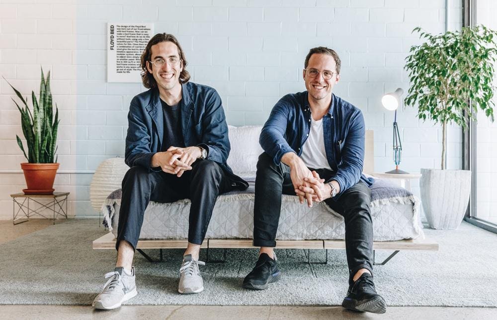 Floyd co-founders Alex O'Dell and Kyle Hoff seated together in a Floyd interior