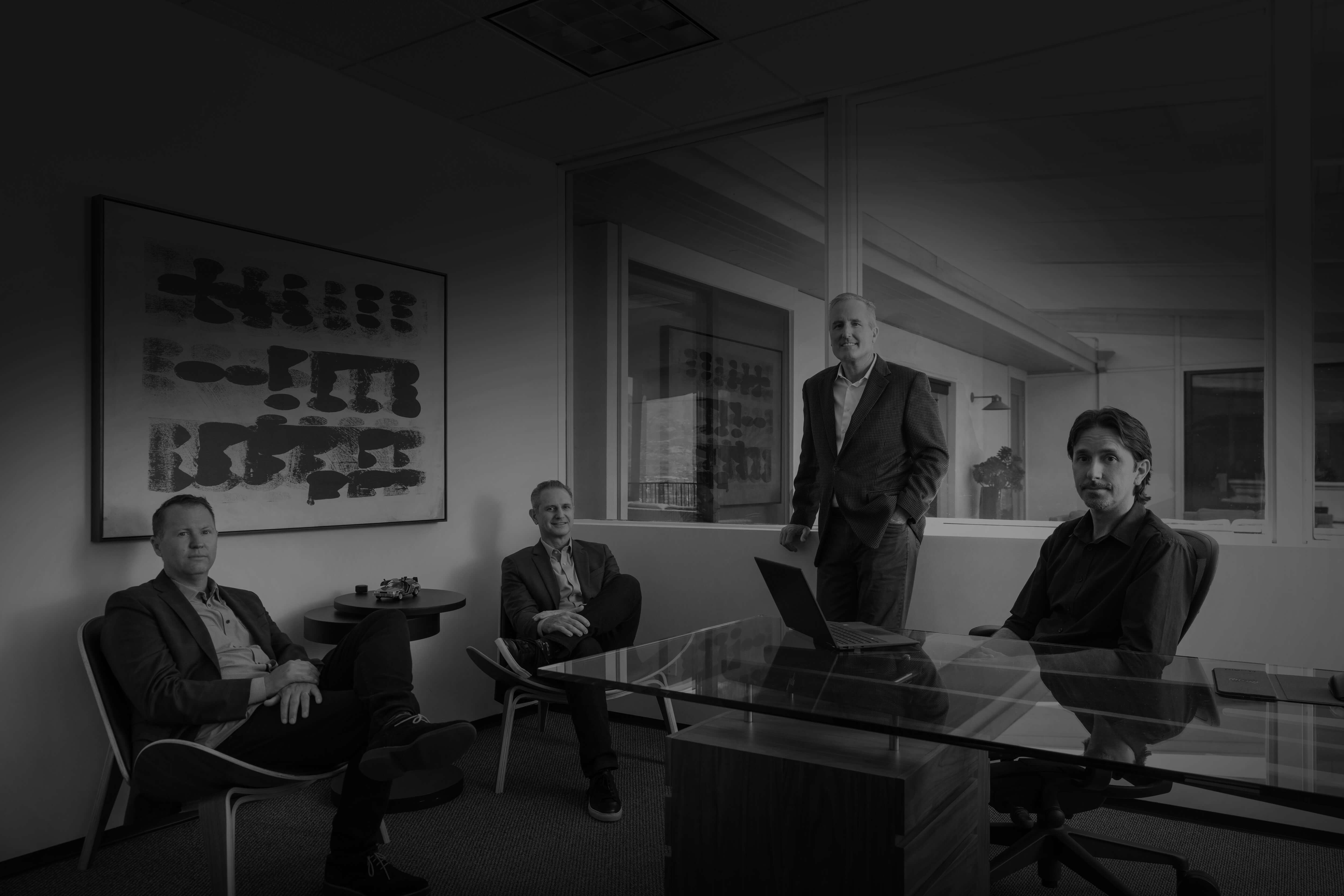 Four members of Flueid's founding and leadership team gathered in an office