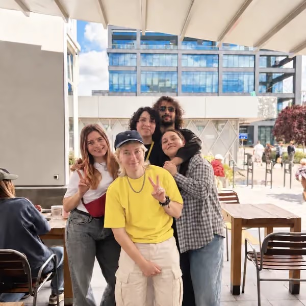 Five Fluxon teammates posing together outdoors