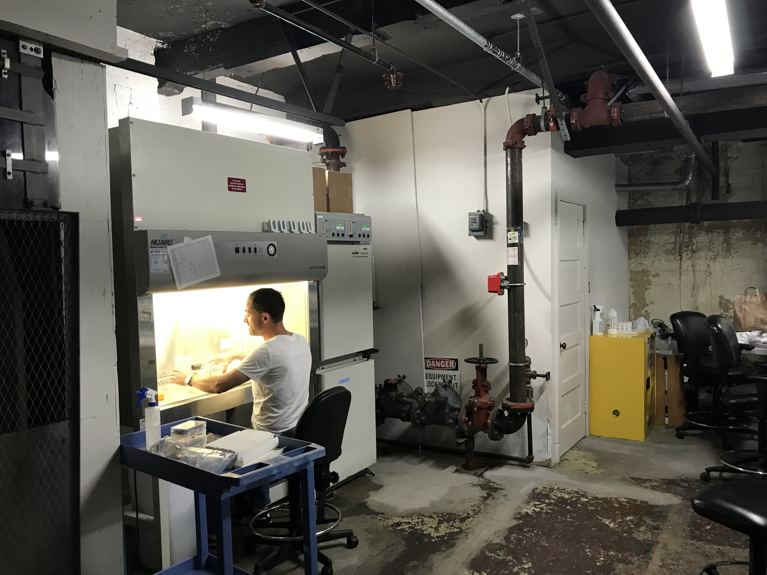 Researcher working at a laboratory cabinet in Focus Academy’s published facilities photograph