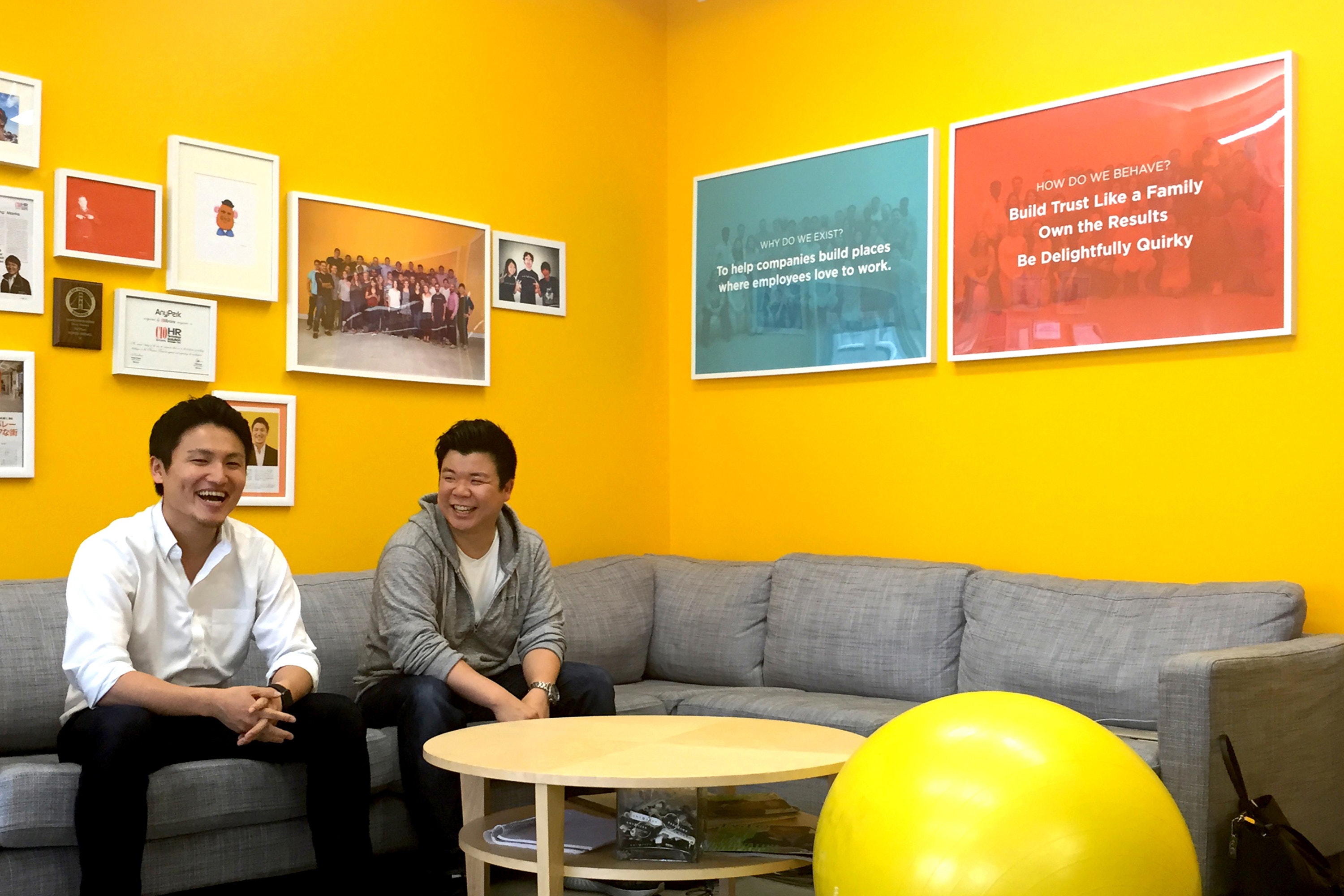 Taro Fukuyama and Sunny Tsang seated in AnyPerk’s yellow office