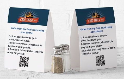 Food Truck Pub tabletop ordering signs with QR codes beside salt and pepper shakers