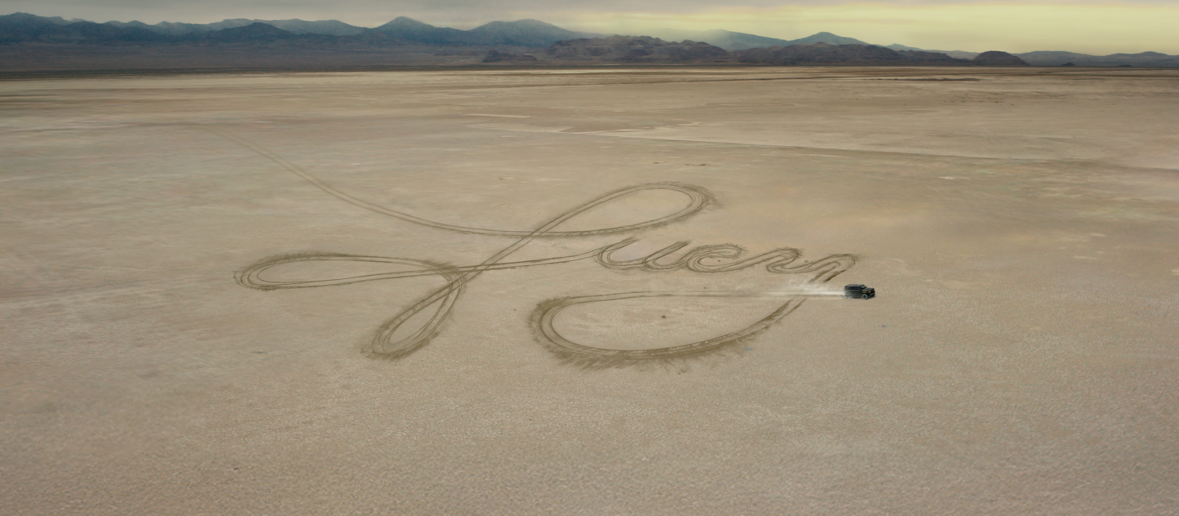 Ford Credit campaign image showing Lucy written in tire tracks across a salt flat