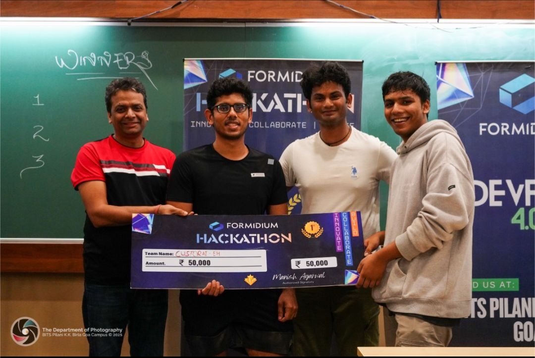 DevFest participants and an organizer hold the first-prize ₹50,000 cheque at BITS Pilani Goa