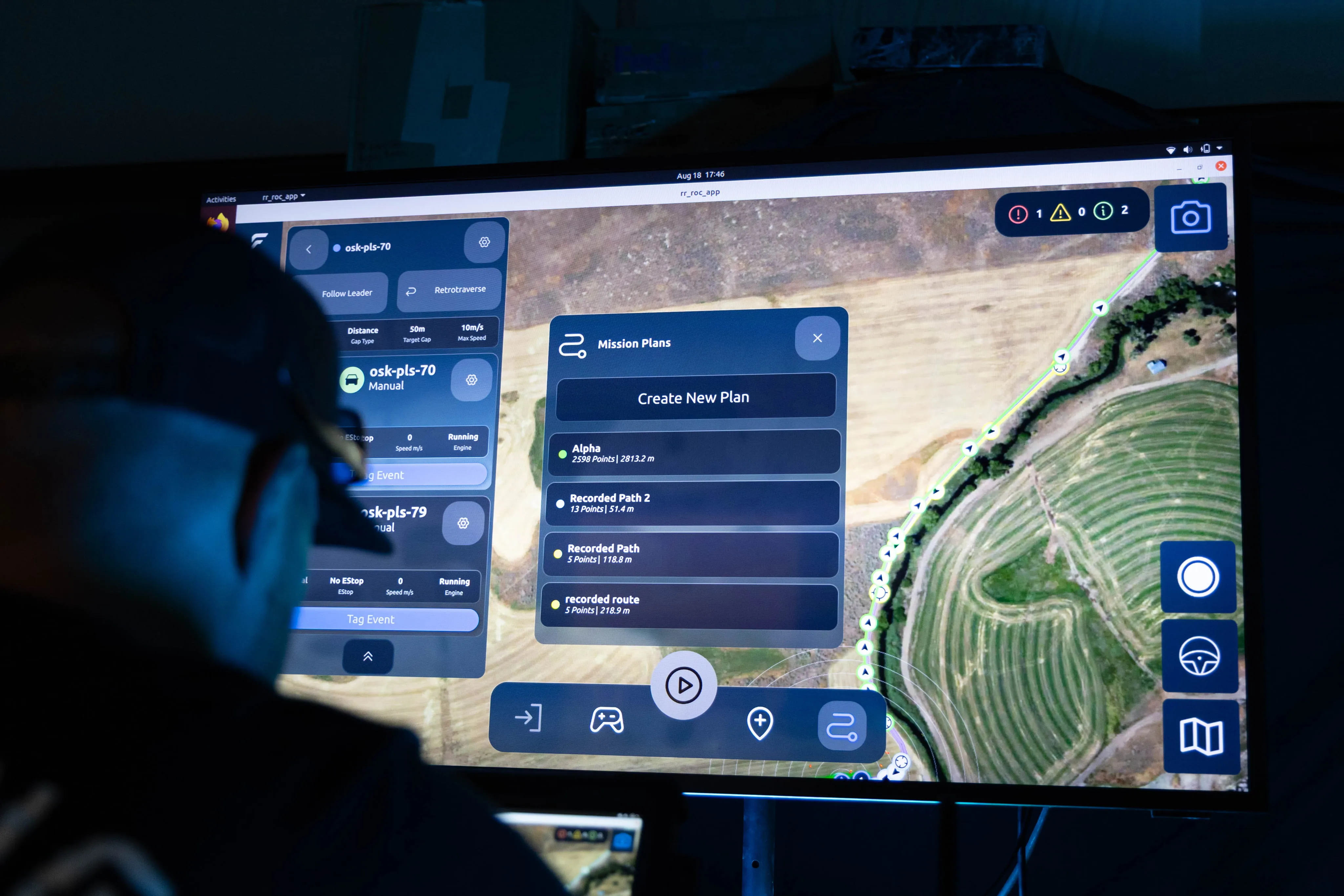 Operator wearing a headset and viewing a map-based mission planning screen