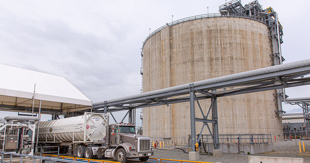 An LNG tanker truck loads beside the large storage tank at FortisBC's Tilbury facility