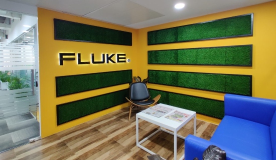 Fluke office reception with yellow walls, green panels and blue seating