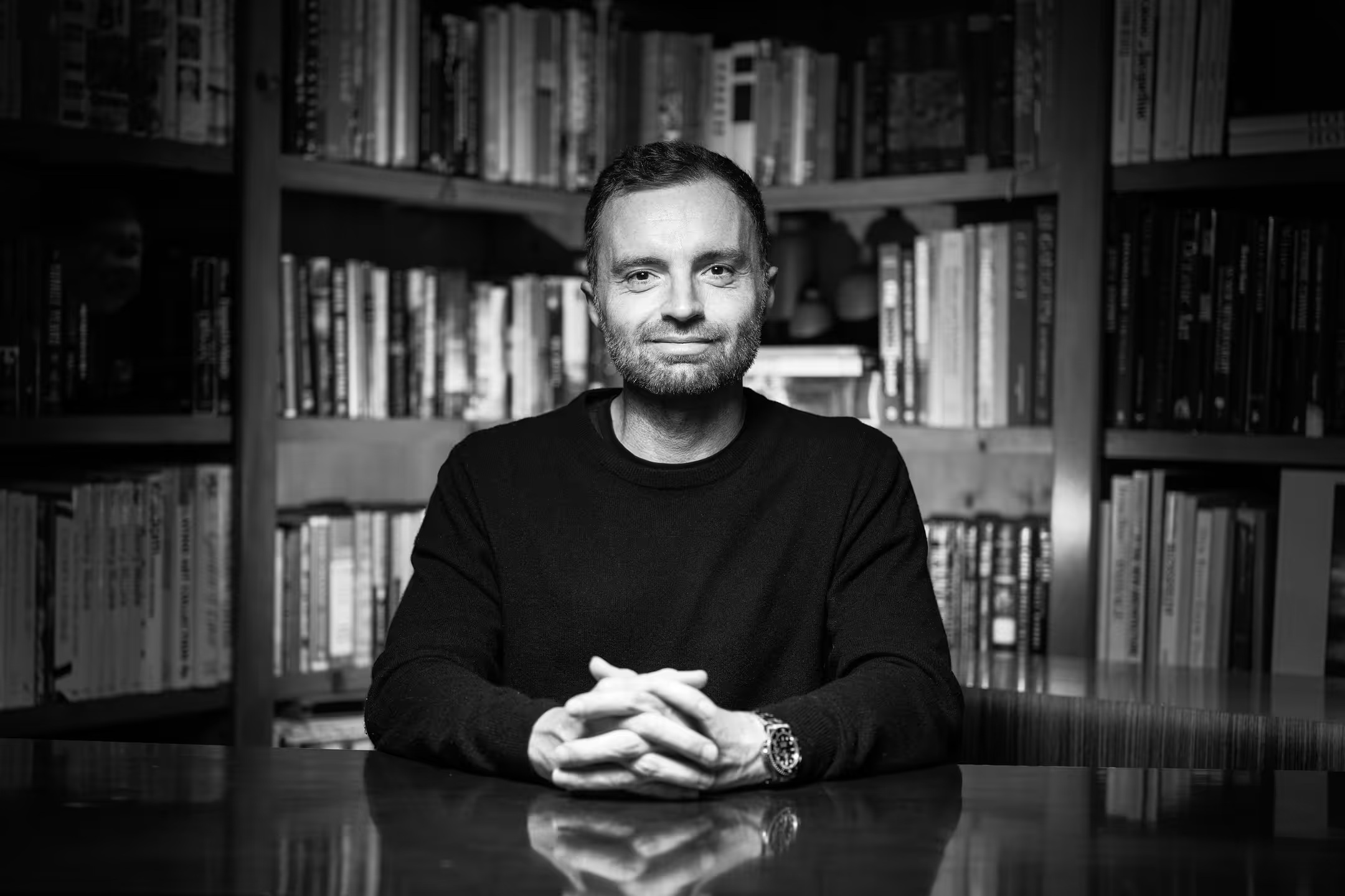 David Senra seated at his desk in front of bookshelves