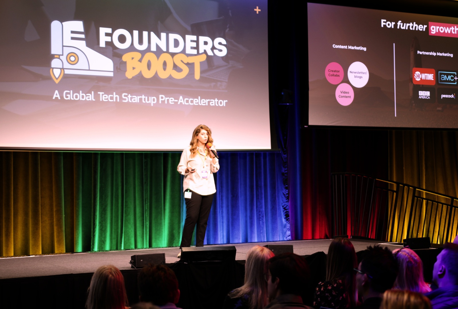 A founder presents a growth strategy on stage at a FoundersBoost demo day