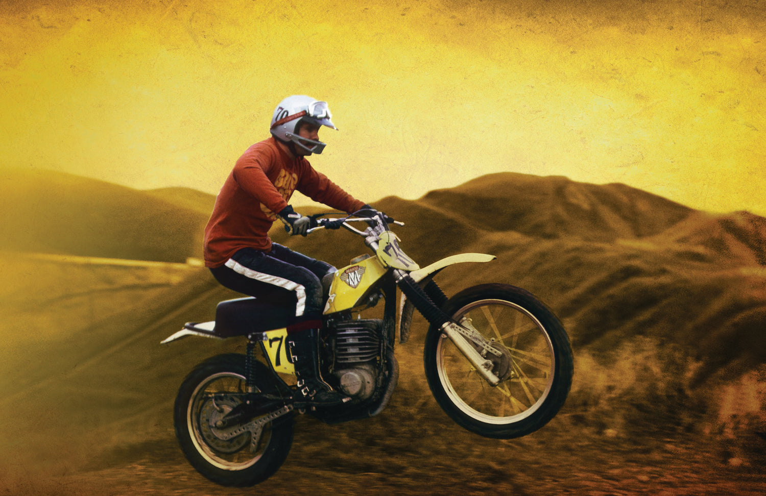 Bob Fox riding a yellow motocross motorcycle on dirt