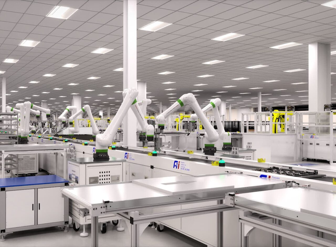 Rows of white industrial robot arms on a Foxconn Industrial Internet production floor