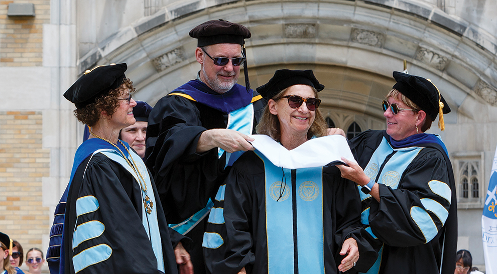Fran Craig smiles as college officials place an honorary degree hood around her shoulders at Saint Mary’s College in 2024.