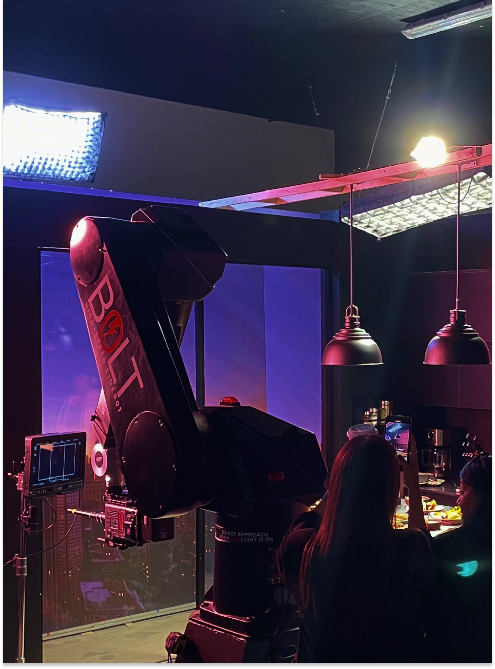 A Bolt camera robot and production crew on 121's illuminated T-fal studio set