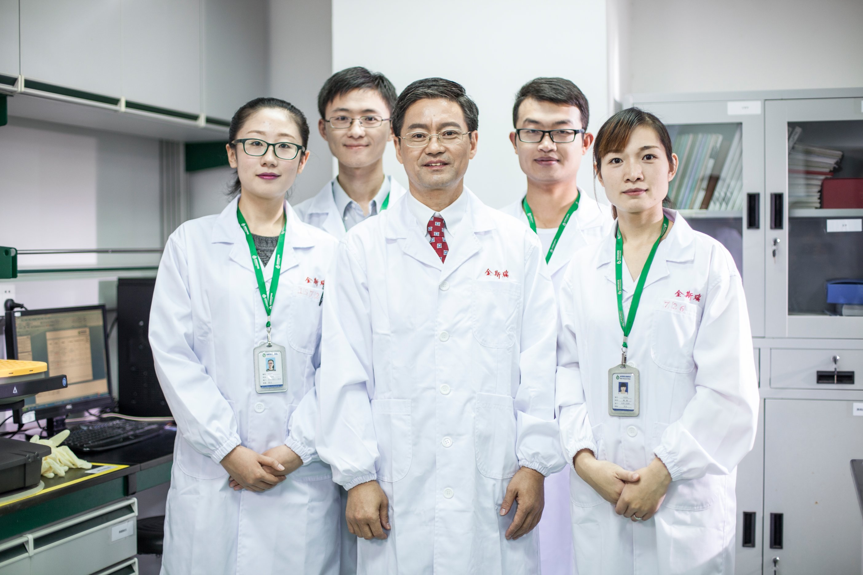 Frank Zhang, center, with four GenScript colleagues in a laboratory