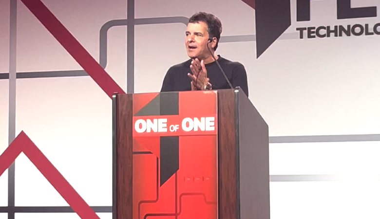 Frank Gaspari speaking behind a One of One podium at FlexTG’s leadership conference