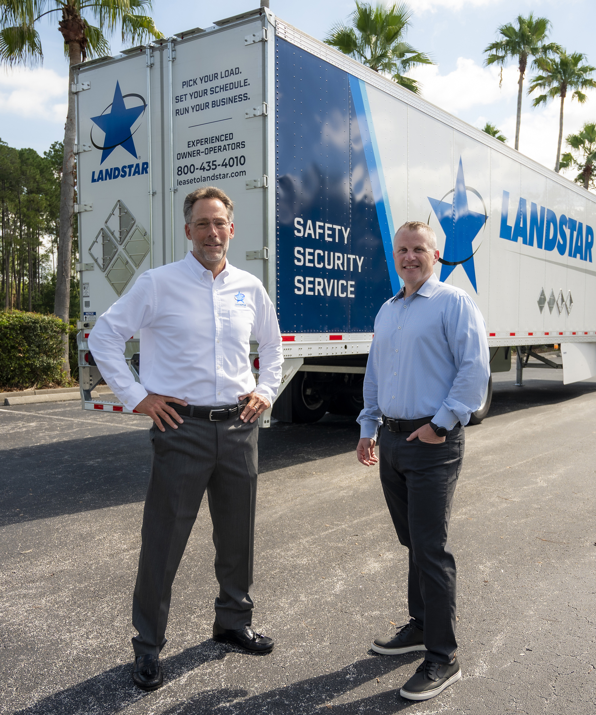 Frank Lonegro, left, and Matt Miller stand beside a newly designed Landstar trailer in Jacksonville