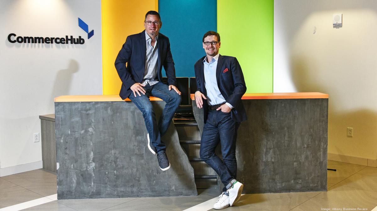 Frank Poore, seated on the left, and Richard Jones at CommerceHub’s reception desk