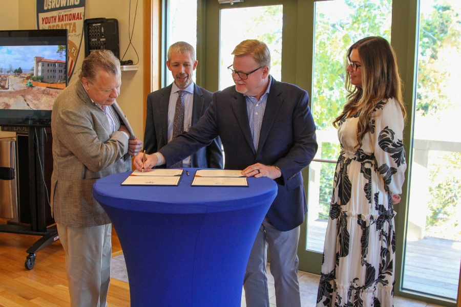 Frank Sanchez at left watches the signing with Tyler Hodges, Dana Fender and Hope Fender at Bolles in October 2023