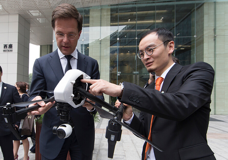 Frank Wang, right, points out features of a DJI aircraft to Dutch prime minister Mark Rutte outside DJI’s headquarters in 2015
