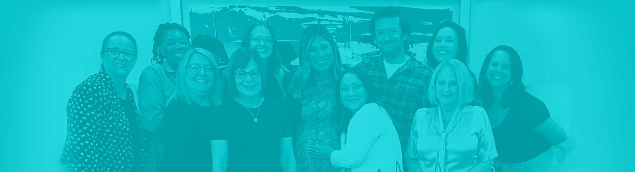 Fraser Communications team in the agency’s turquoise-tinted group photograph