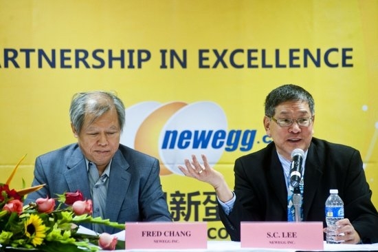 Fred Chang seated at left beside S.C. Lee at a Newegg press event, with their names on the table.