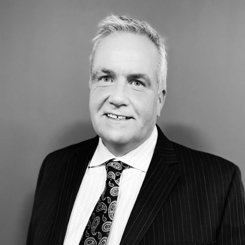 Black-and-white portrait of Fred Edwards in a suit
