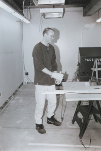 An archival photograph of Fred Ewald making wooden office desks