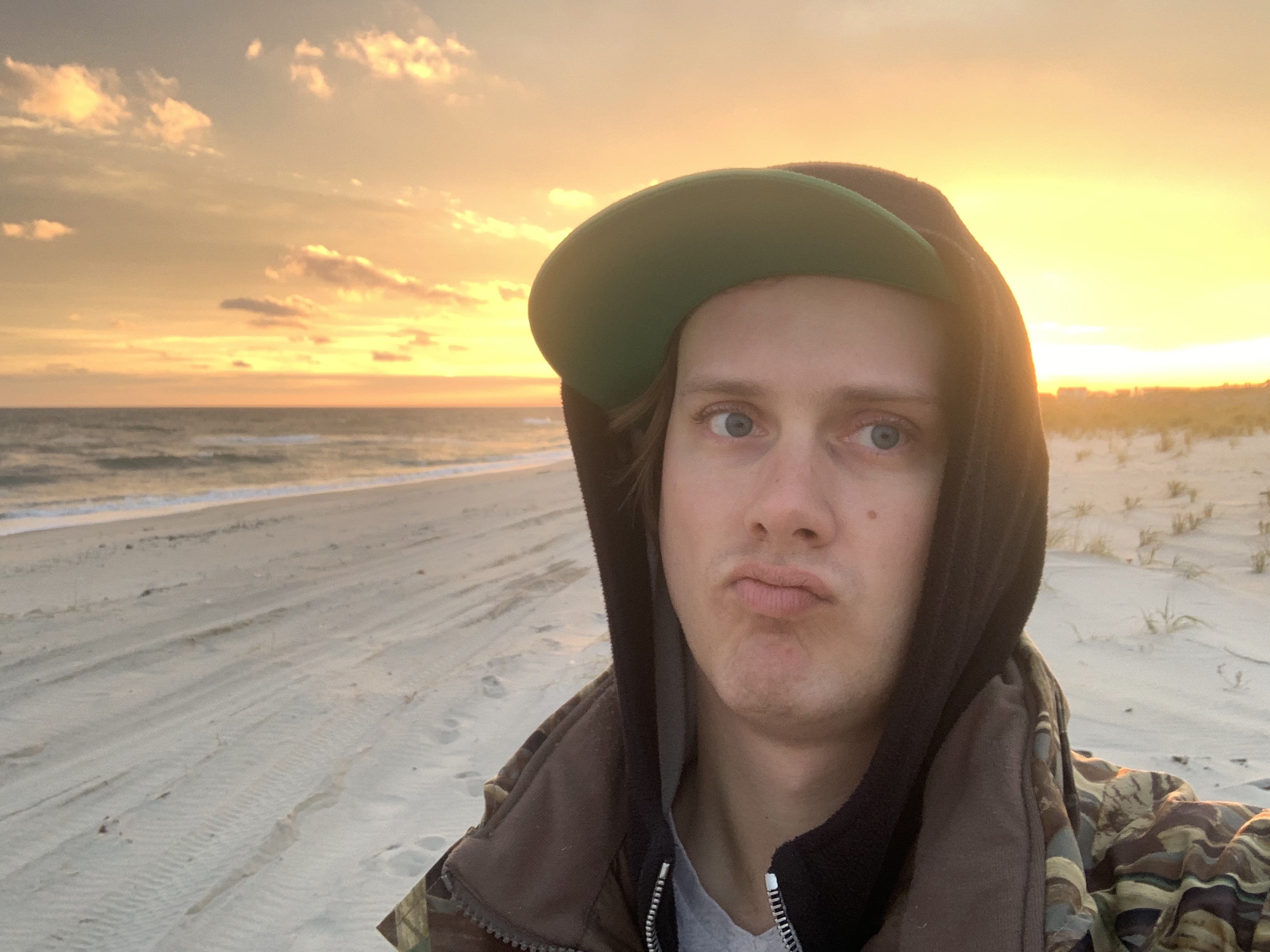 Fred Havemeyer makes a comic expression beside the ocean at sunset