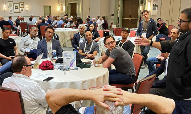 Fred Hsu, seated left of centre in a grey jacket, joins a round-table discussion with domain industry attendees.