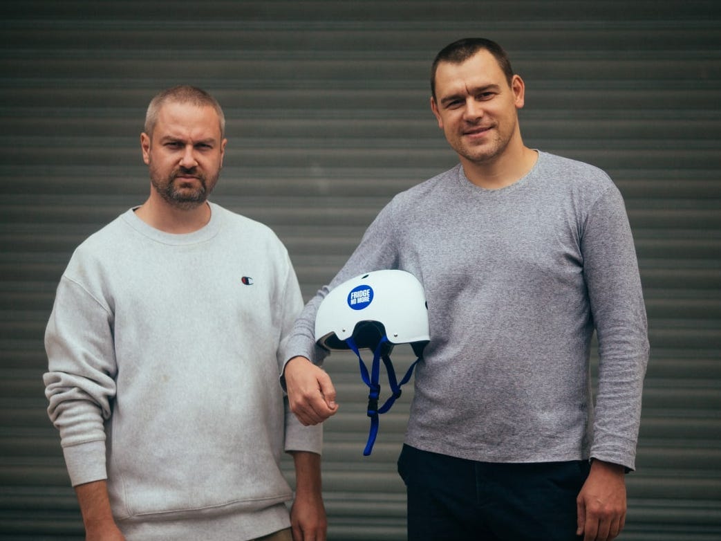 Anton Gladkoborodov on the left and Pavel Danilov on the right, holding a company helmet