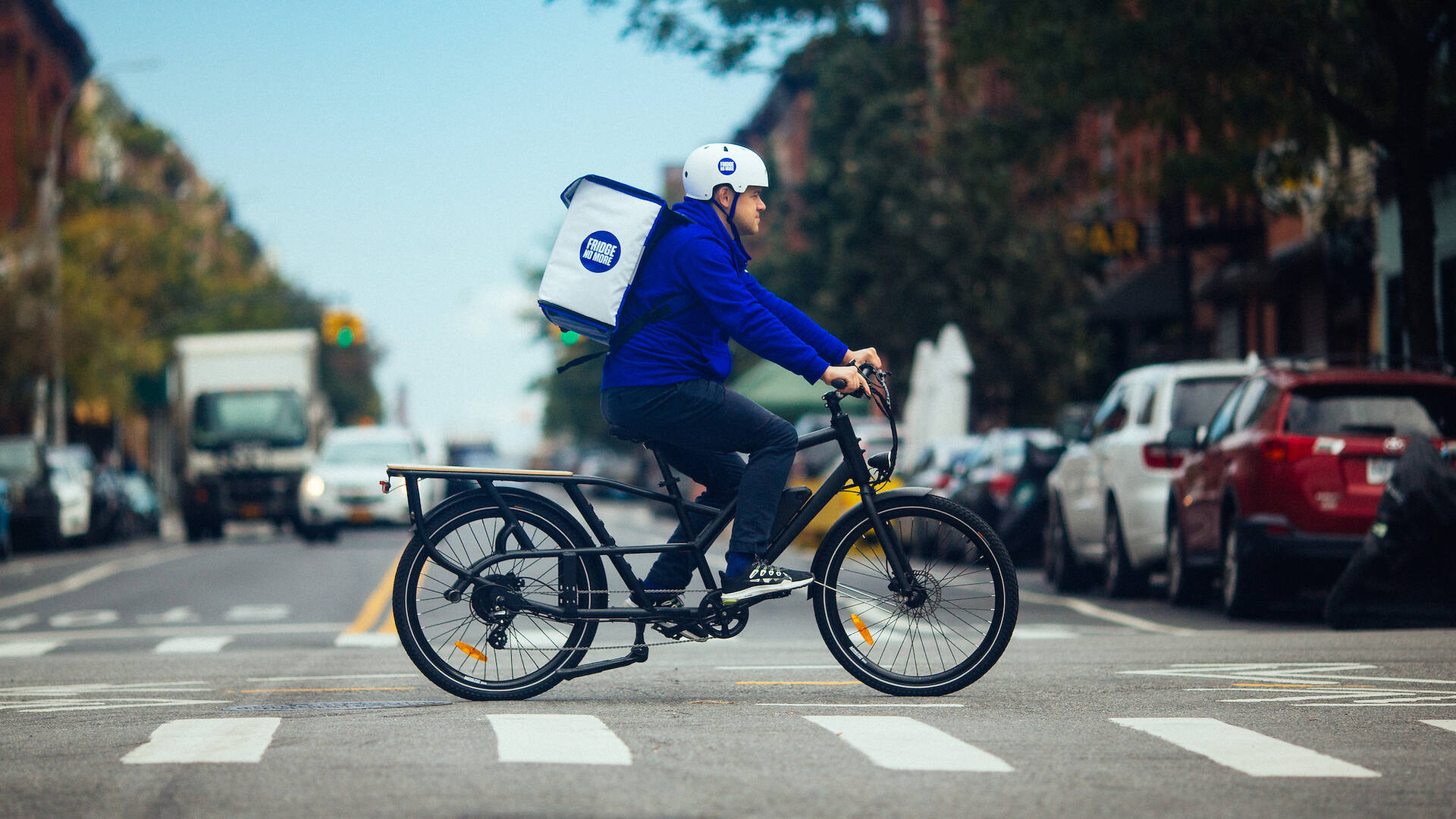A Fridge No More courier on a bicycle on a New York street