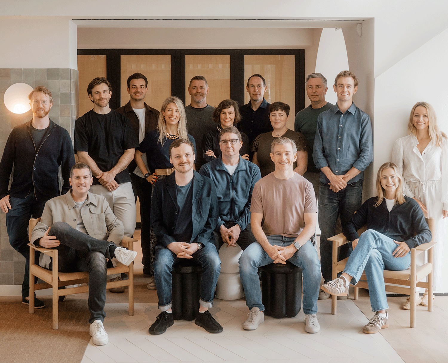 Frontline Ventures team gathered in a bright room, with colleagues seated and standing