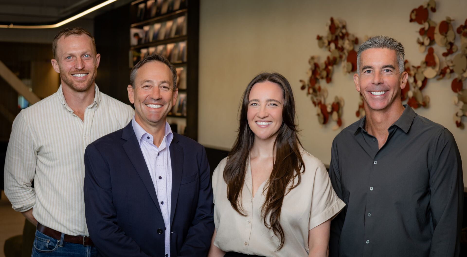 Frontline founder Harry Statter standing with Scott Mitchell, Cassie McHenry, and Jon Kossow of Norwest