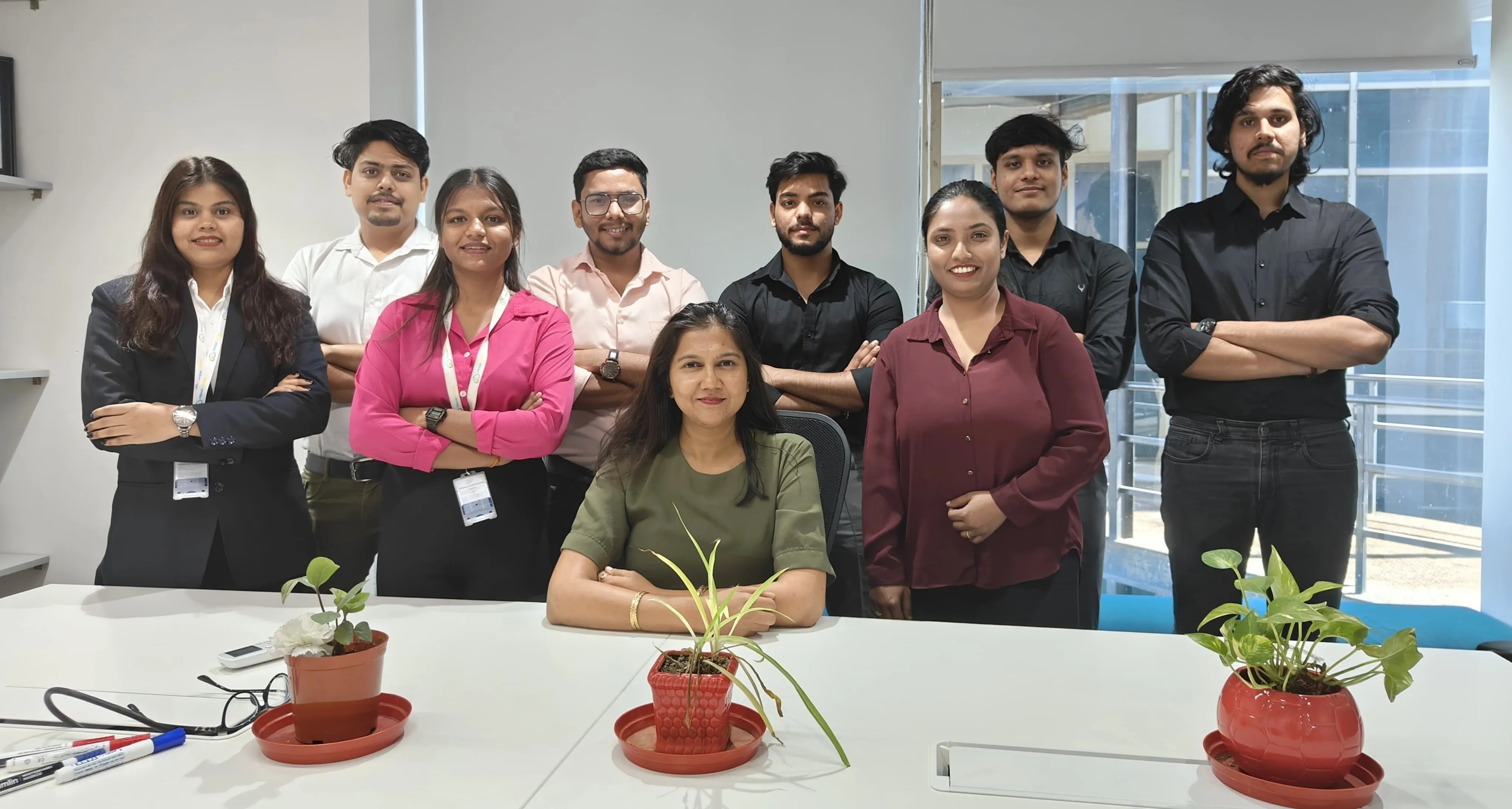 Members of the Frugal Testing team gathered around a table in their office