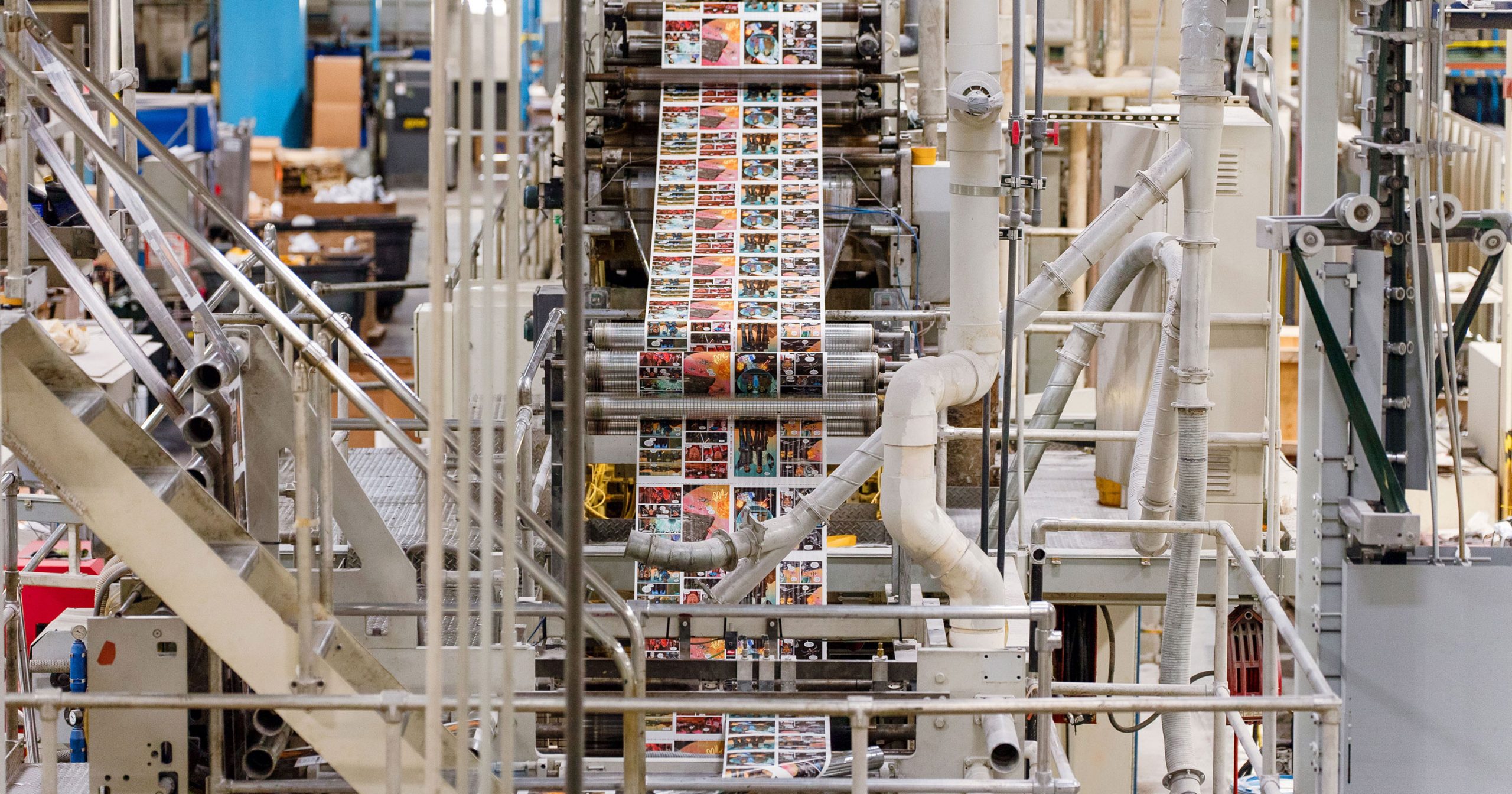 A printed paper web travels through machinery in Fry’s pressroom